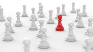 Image of a red chess piece in a crowd of white pieces, symbolizing brand differentiation.