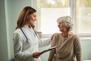 Female Doctor talking with Female elderly Patient